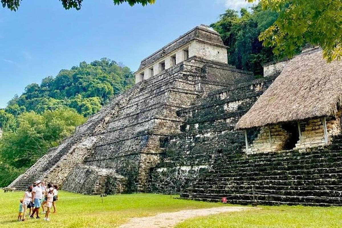 a group of people standing in front of a pyramid