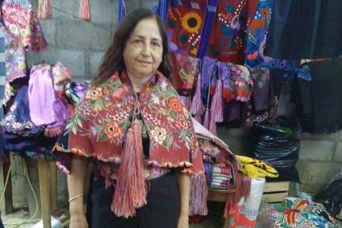 a woman standing in front of a display of clothing