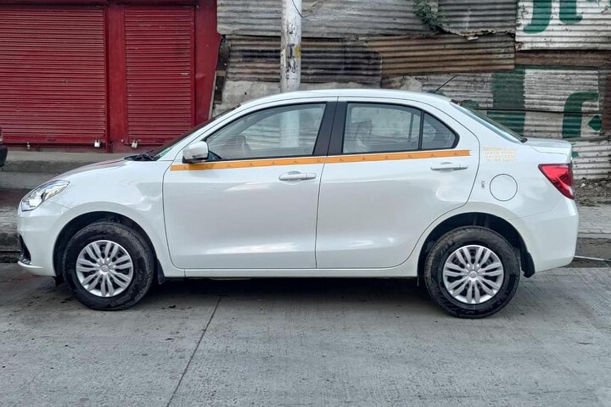 a white car parked on the side of a street