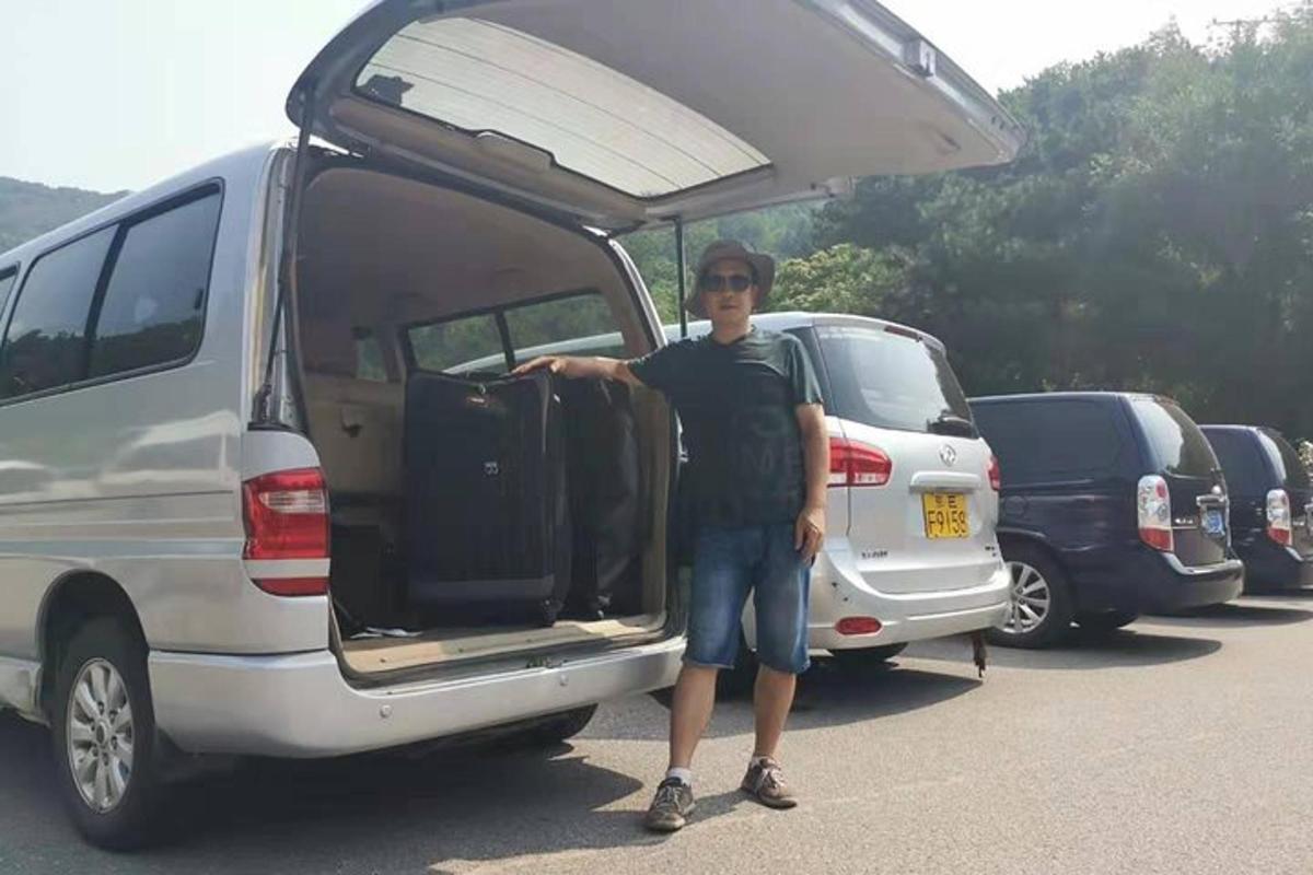a man standing in front of a van with its door open