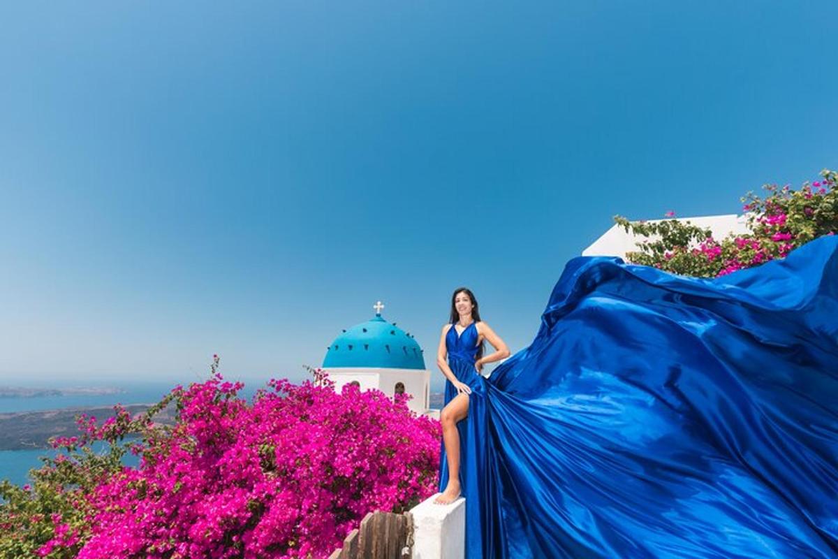 a woman in a blue dress sitting on a building with flowers