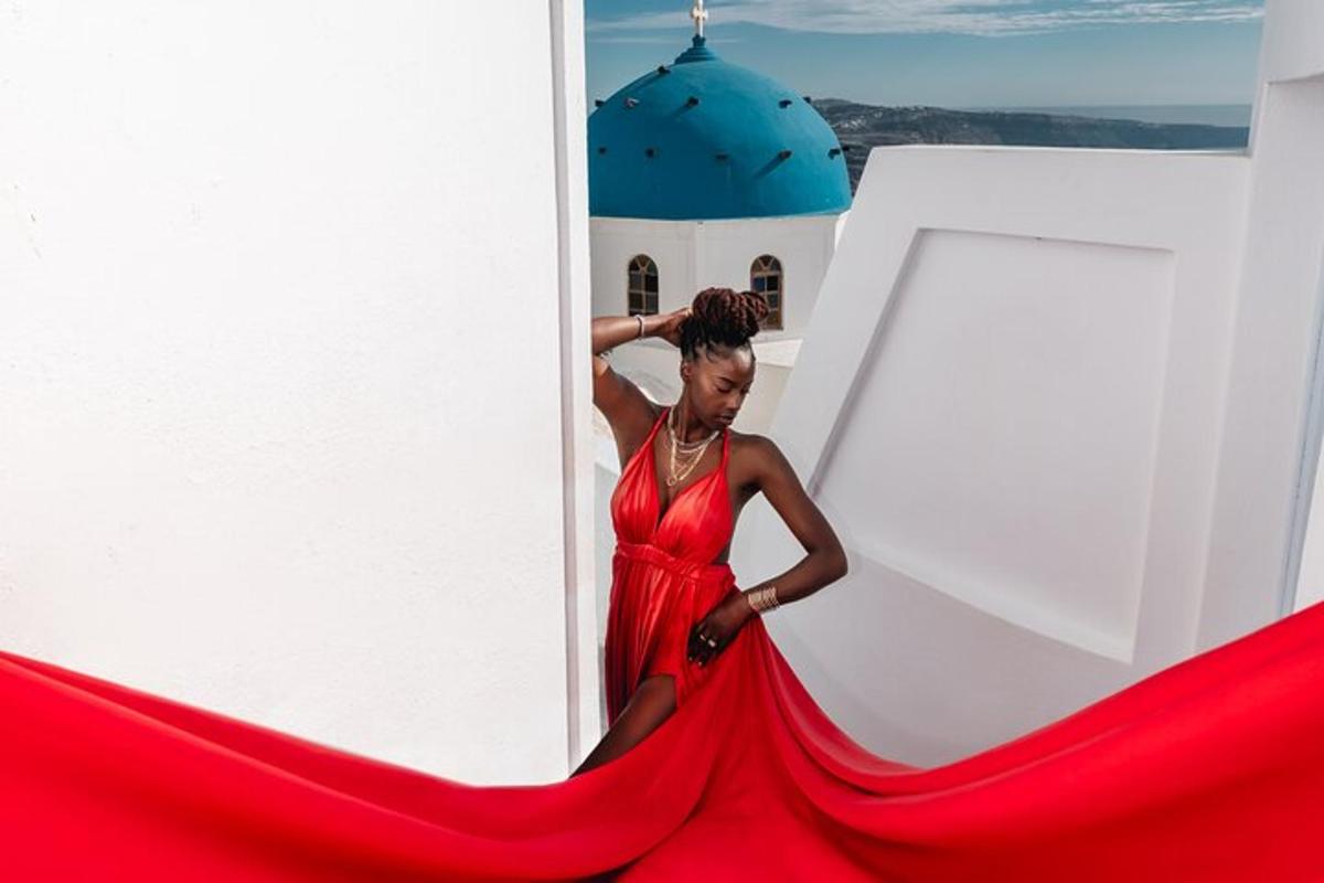 a woman in a red dress standing on a building