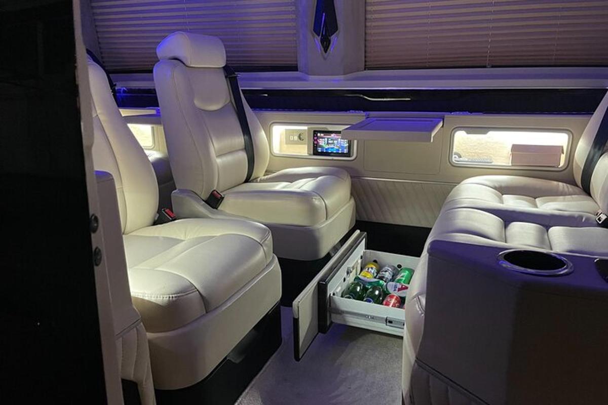 an aisle of an airplane with the seats and drinks