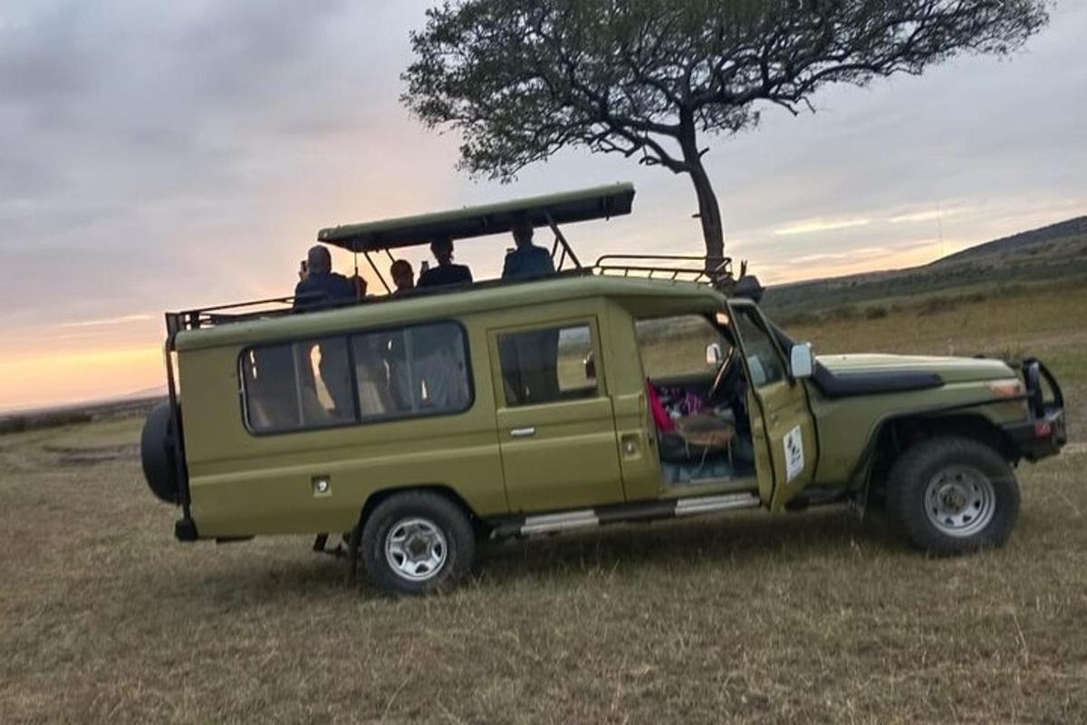 a green jeep with people sitting in the back