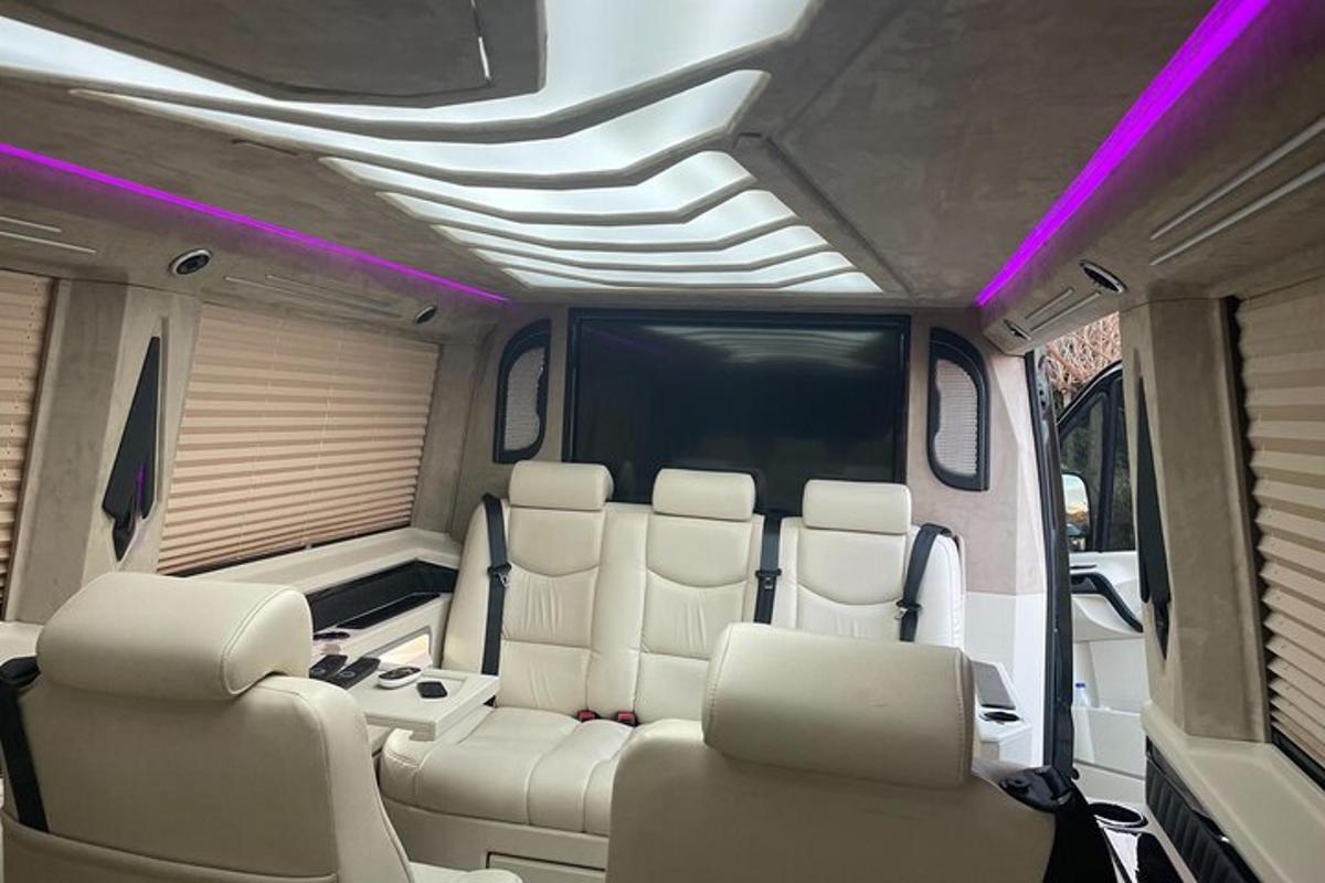 a limo with white seats and purple lights