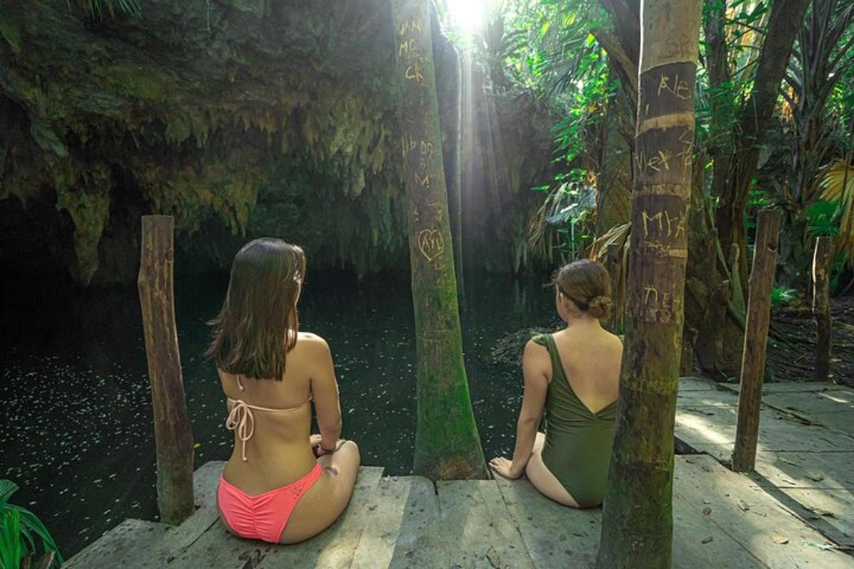 two women sitting on a bridge in the jungle