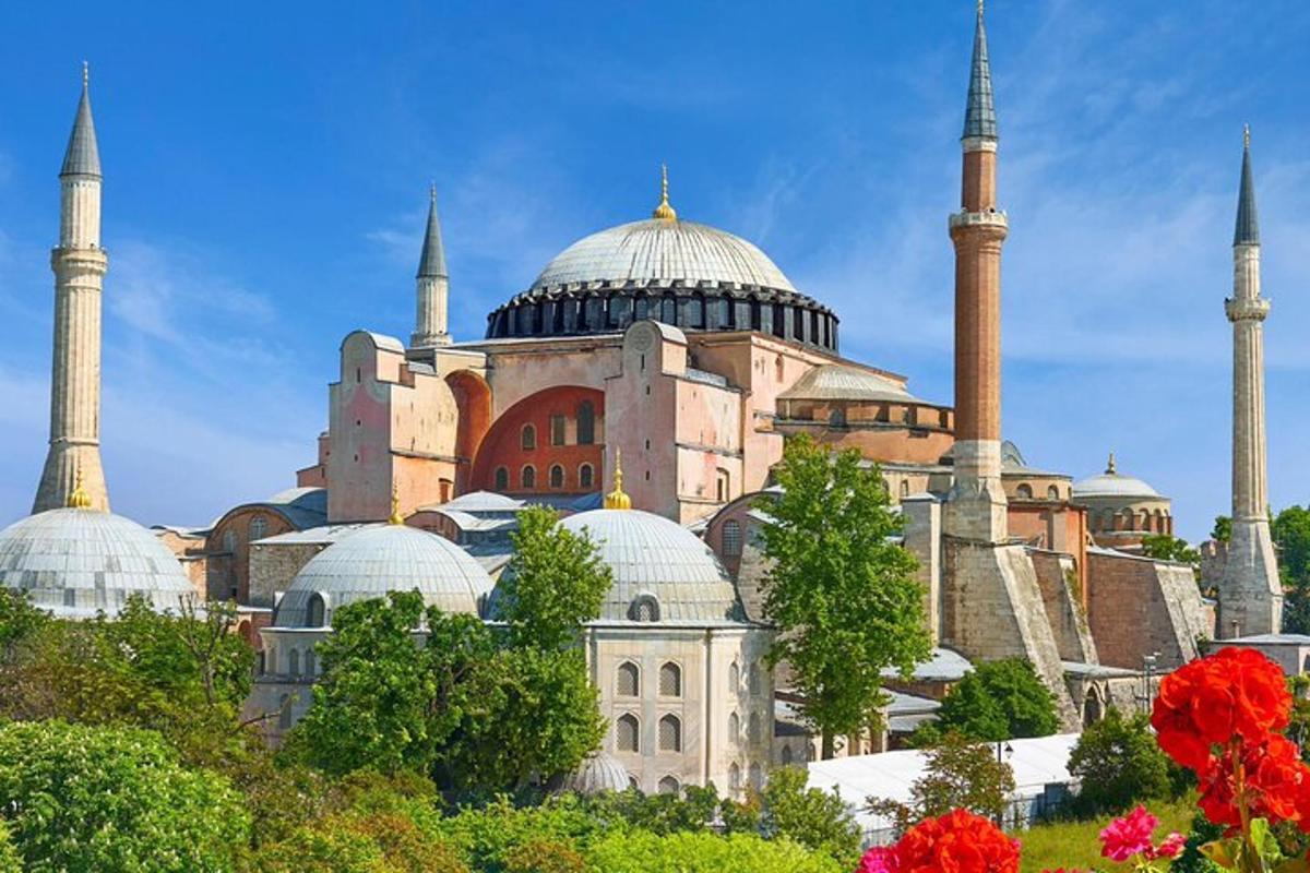 a large building with domes and mosques on a hill