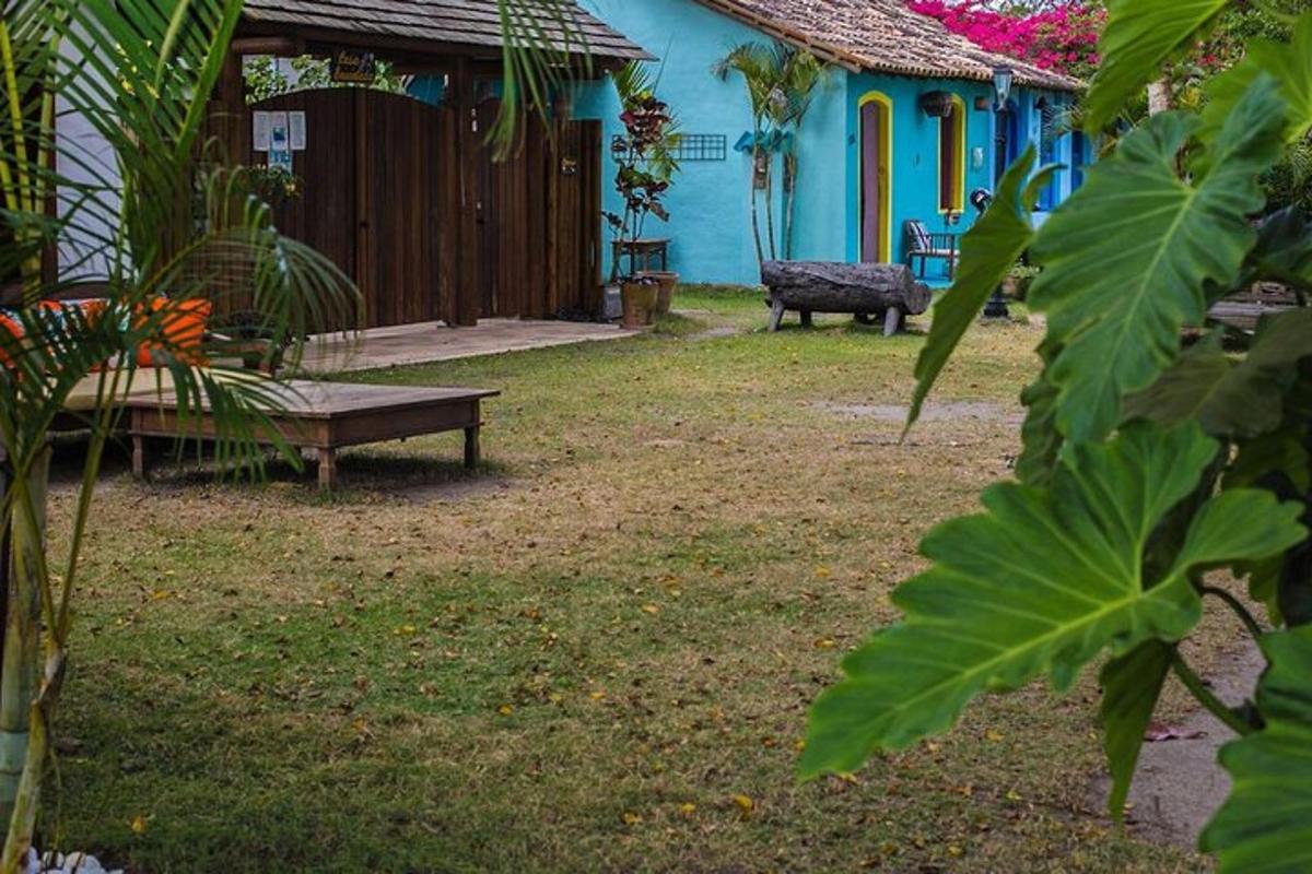 a yard with a bench and a blue house