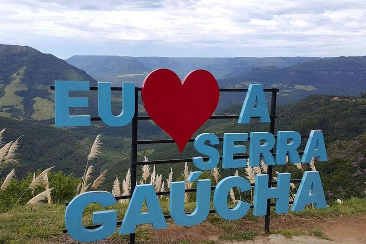a sign with a heart on top of a mountain