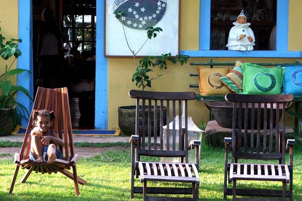 a dog sitting in two rocking chairs in the grass