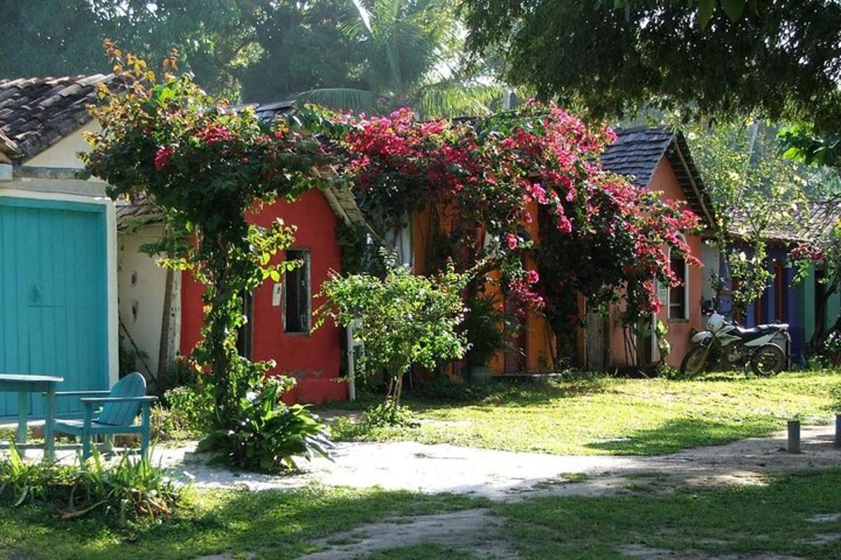 a red house with flowers on the side of it