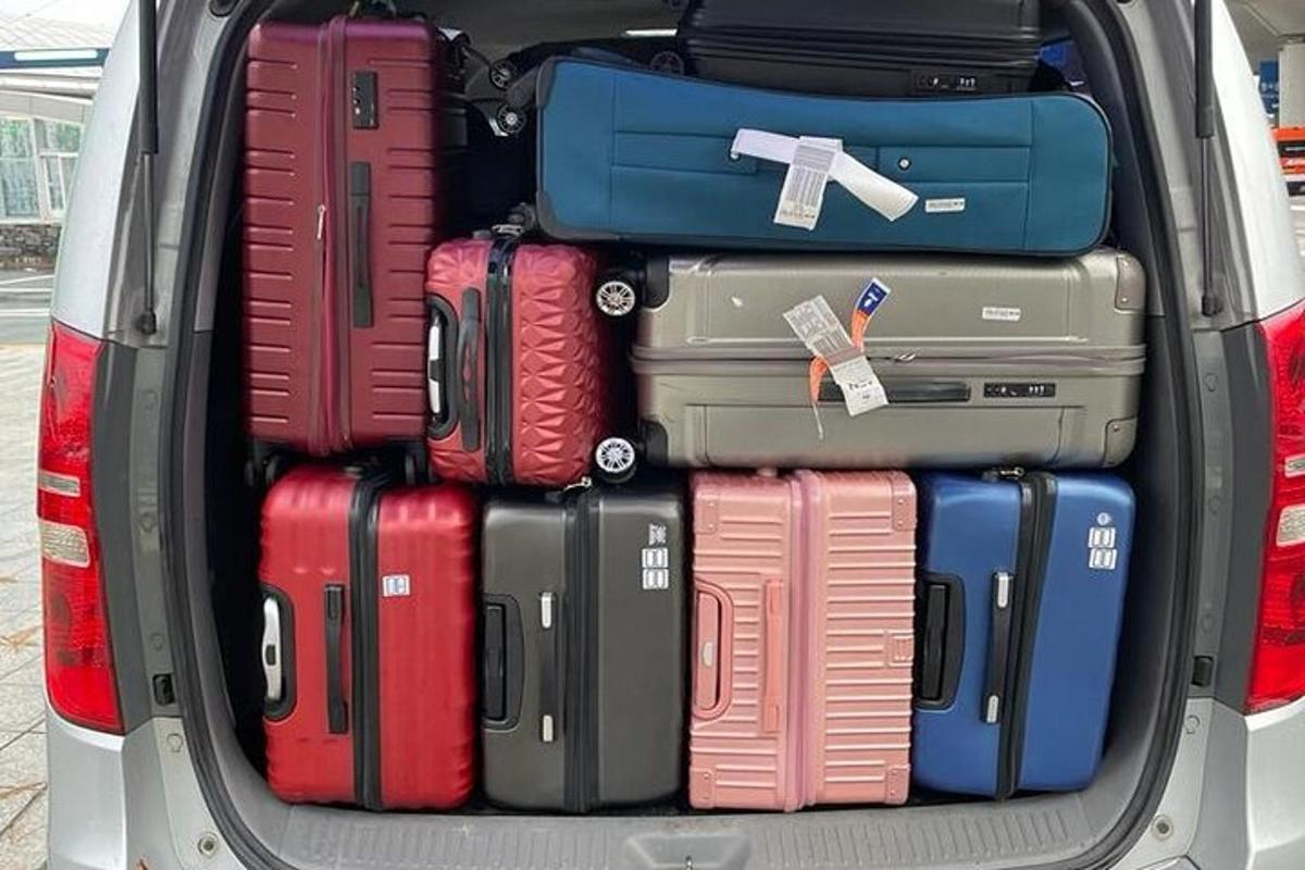 a trunk full of luggage in the back of a car