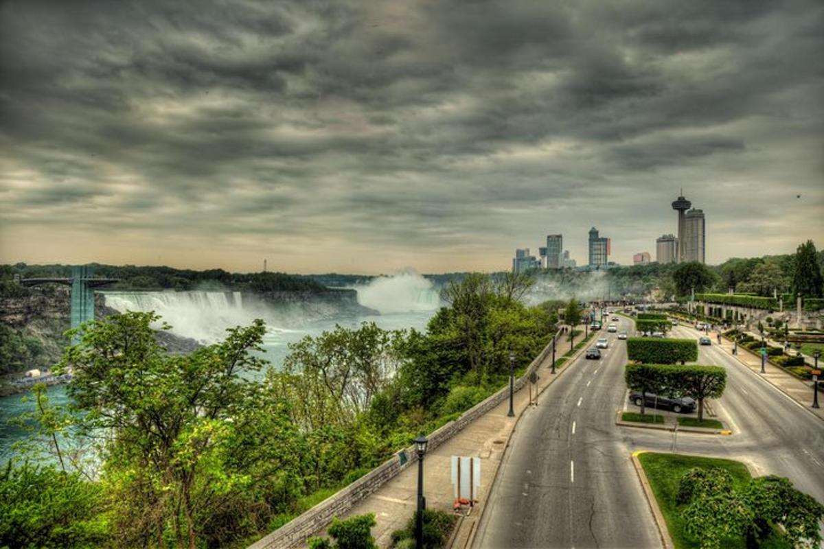 a road with a view of a river and a city