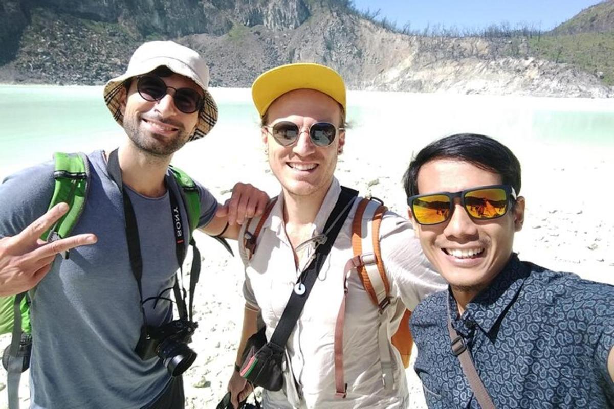 three men posing for a picture at the beach