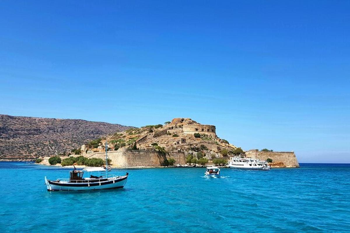 two boats in the water with an island in the background