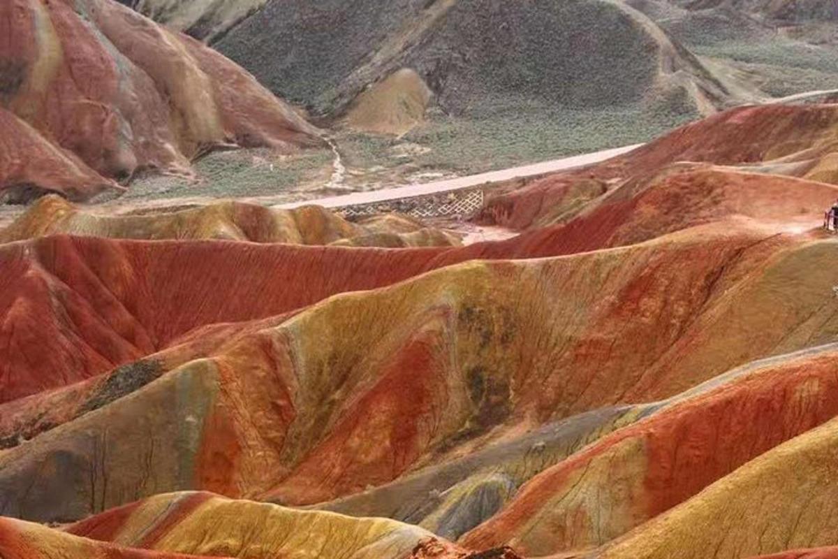 a painting of a mountain with colorful rocks
