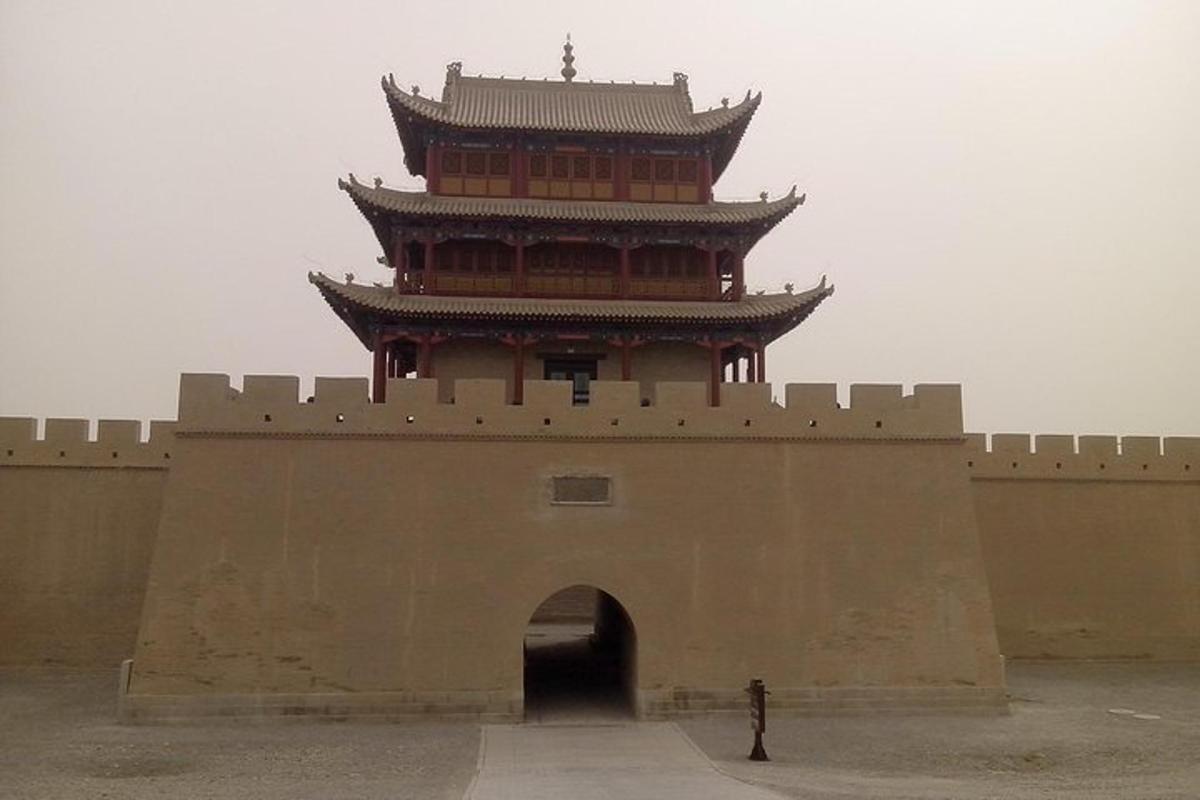 a tall building on top of a wall with an arch