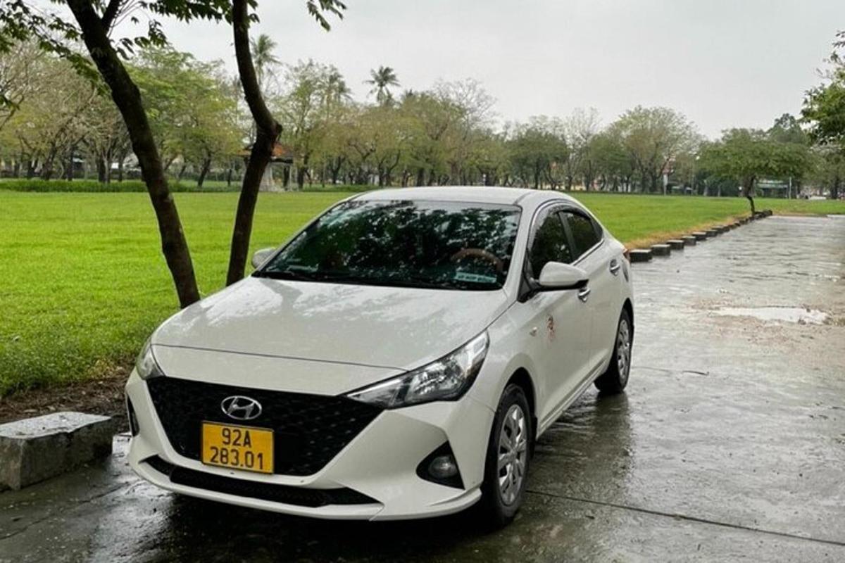a white car parked on a wet street