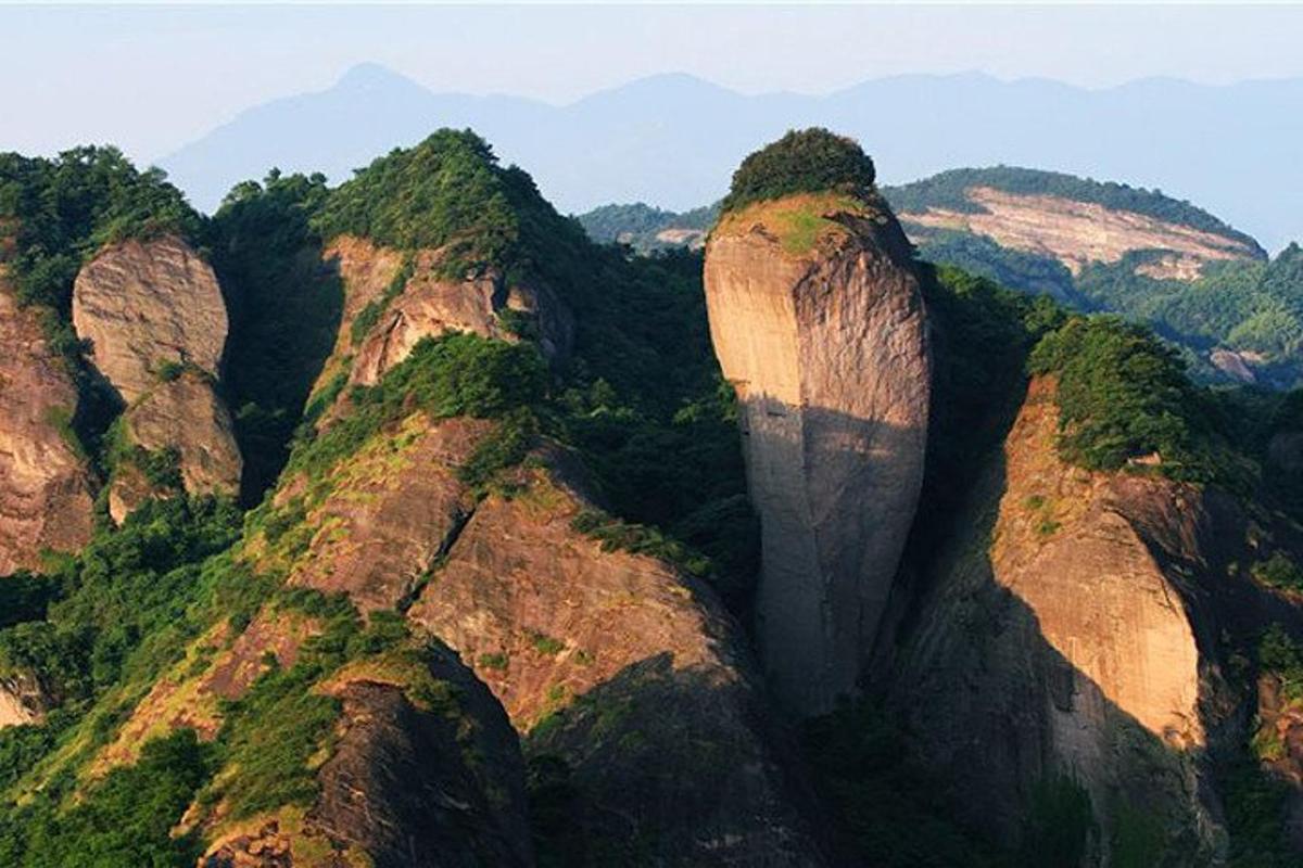 Una vista de una cadena montañosa con árboles y rocas.