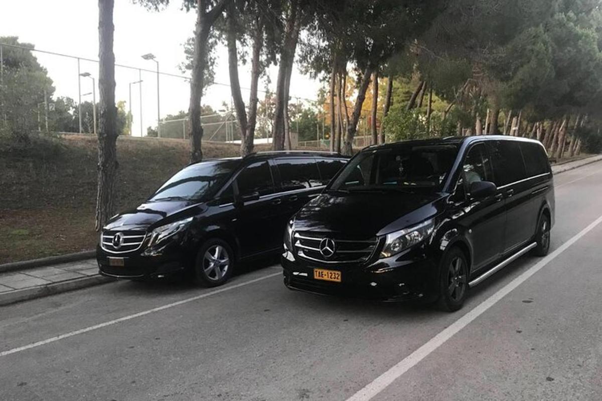 two black cars parked on the side of a road
