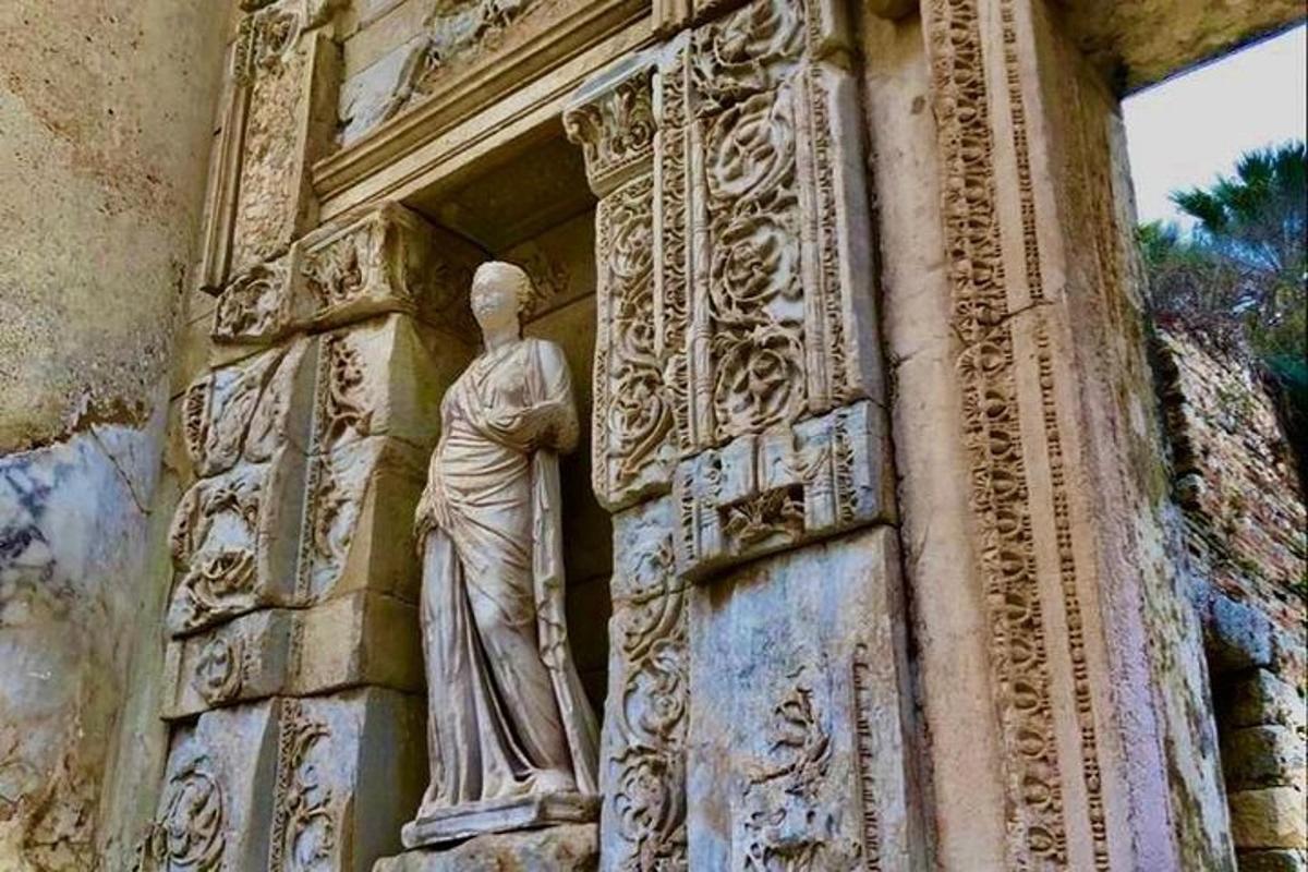 a statue of a woman on the side of a building