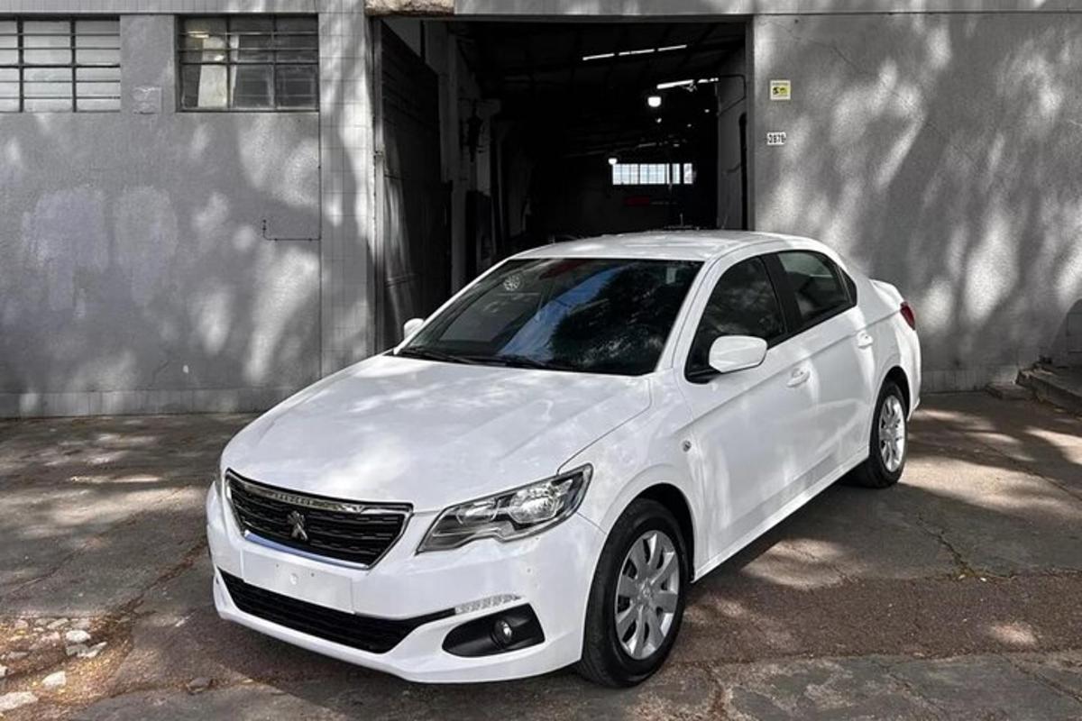um carro branco estacionado em frente a uma garagem