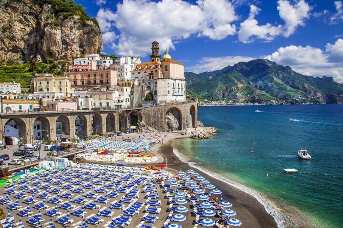 a beach with a bunch of umbrellas and the ocean