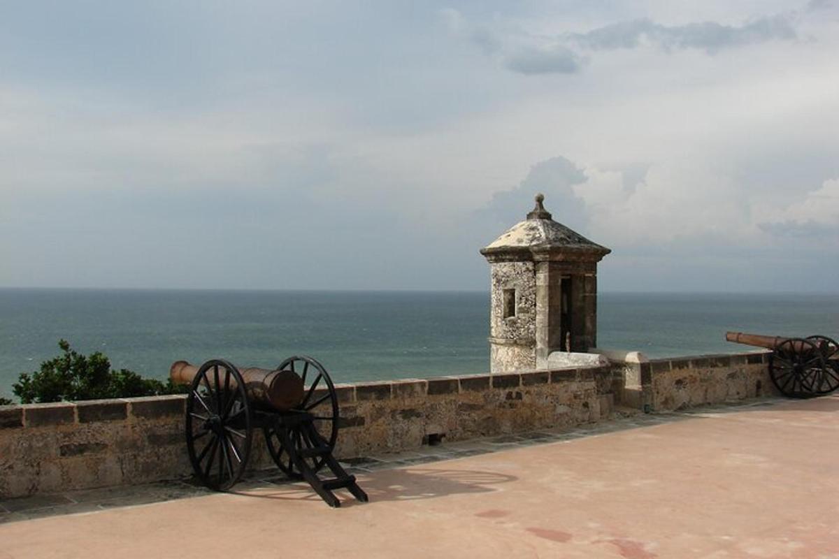 a stone wall with a bench and a tower