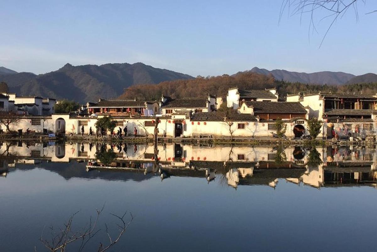 a group of buildings sitting next to a body of water