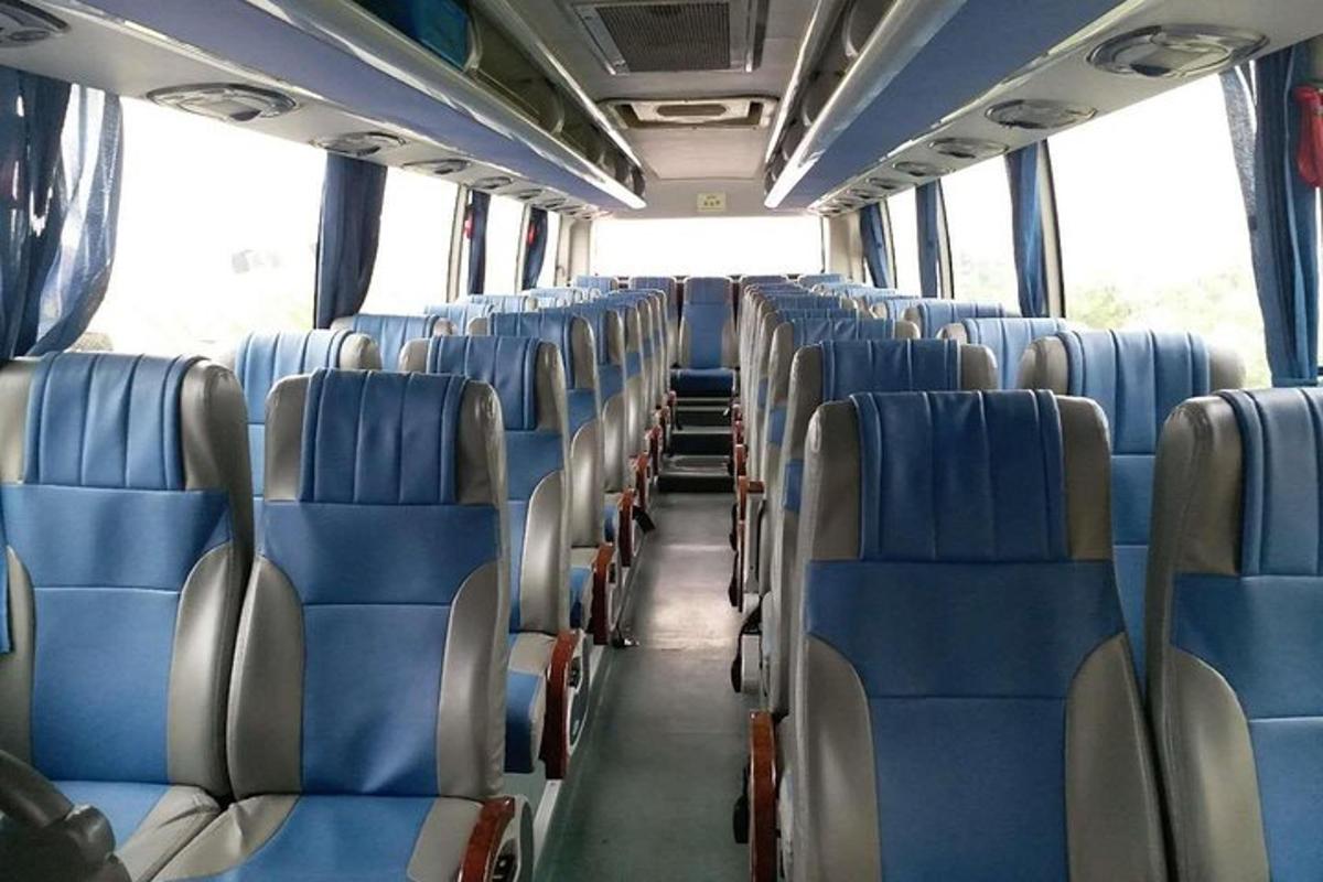 an empty bus with blue seats on a bus