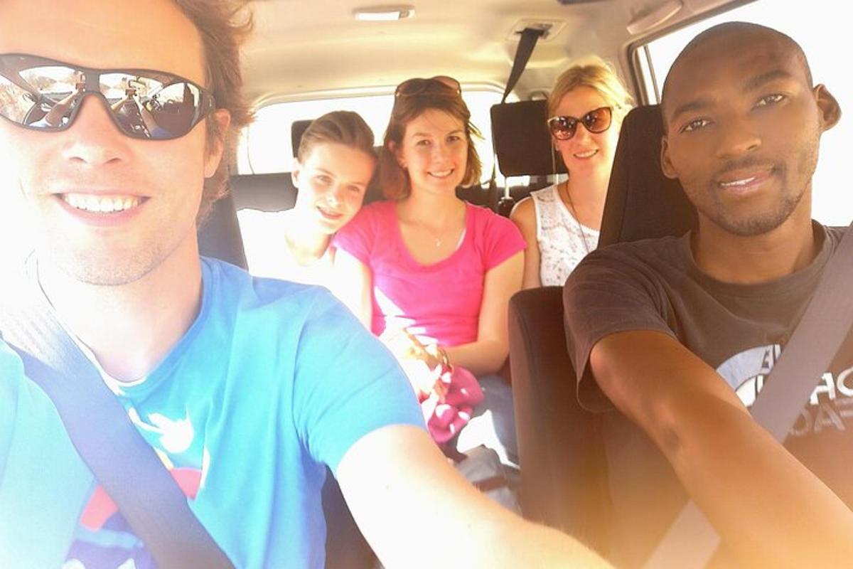 a group of people sitting in the back of a van