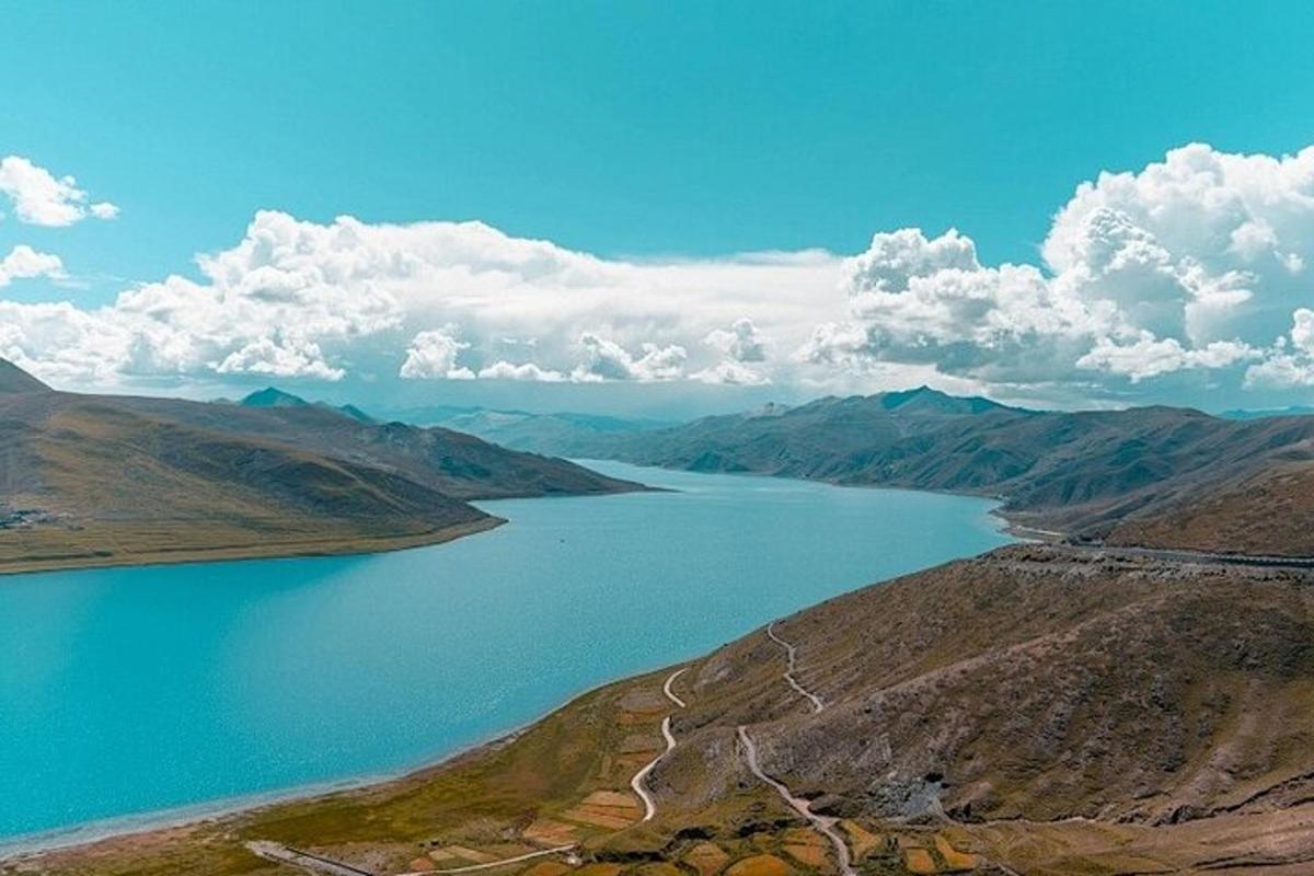 an aerial view of a lake in the mountains