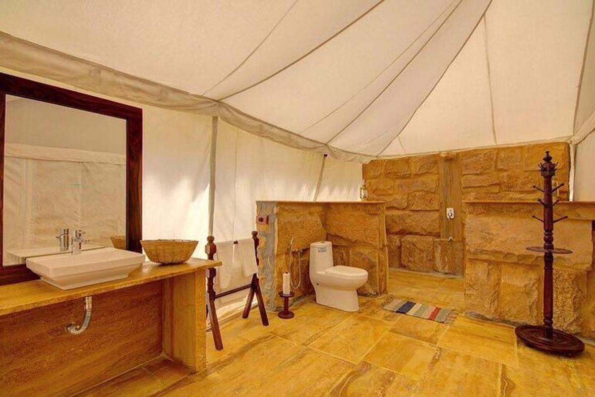 a bathroom with a sink and a toilet in a tent