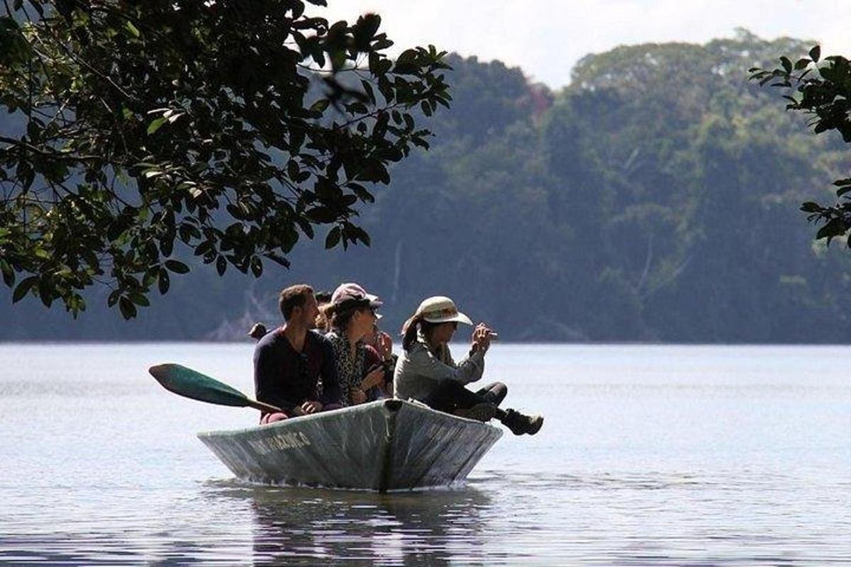 a group of people sitting in a boat on the water