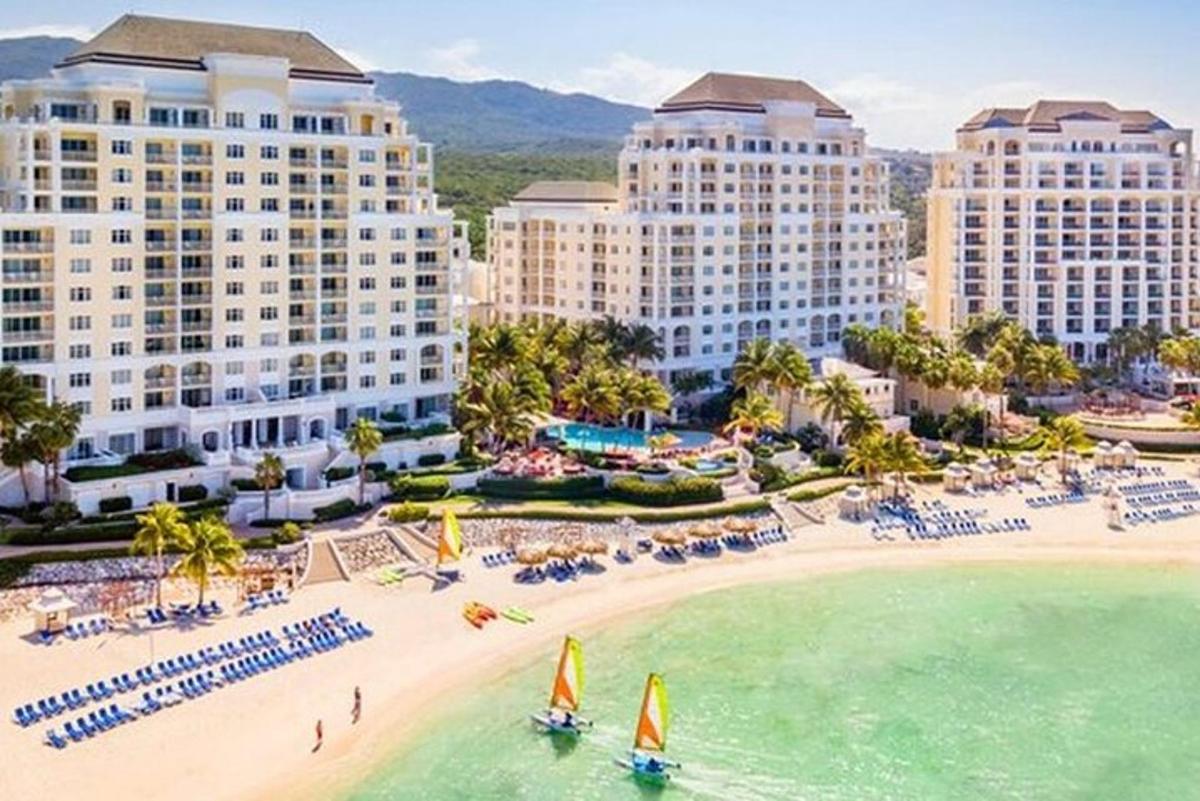 an aerial view of a resort with a beach and buildings