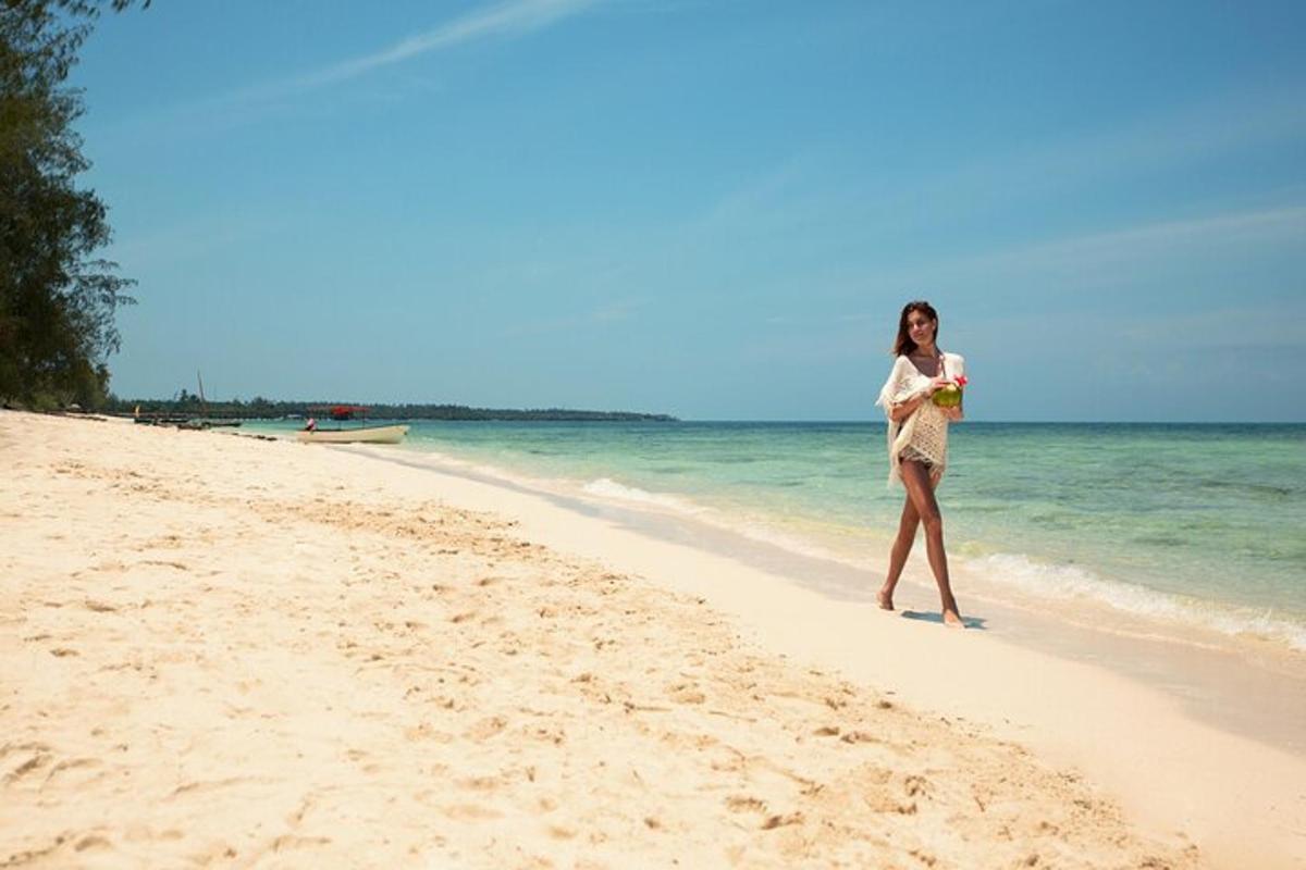 a woman standing on a beach near the ocean