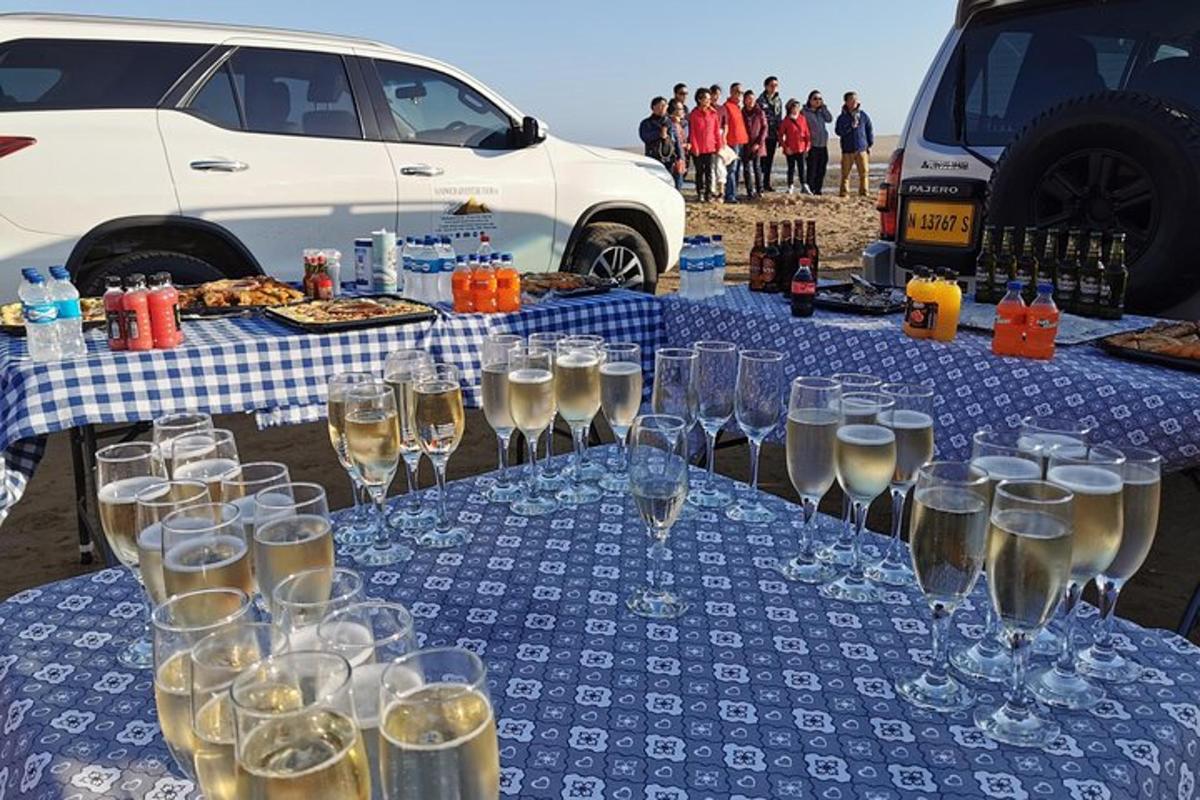 a table with glasses of wine on a blue table cloth