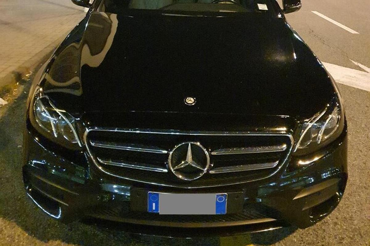 a mercedes benz car parked in a parking lot