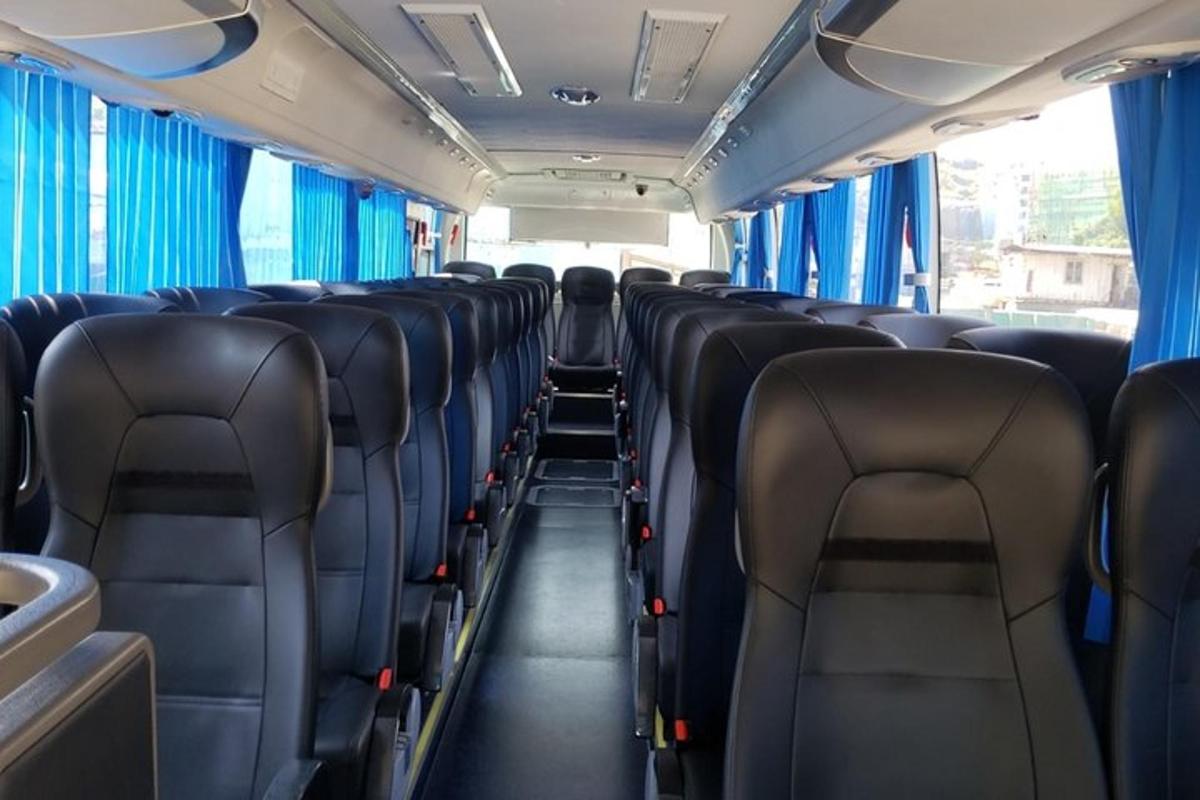 an empty train car with blue curtains and seats