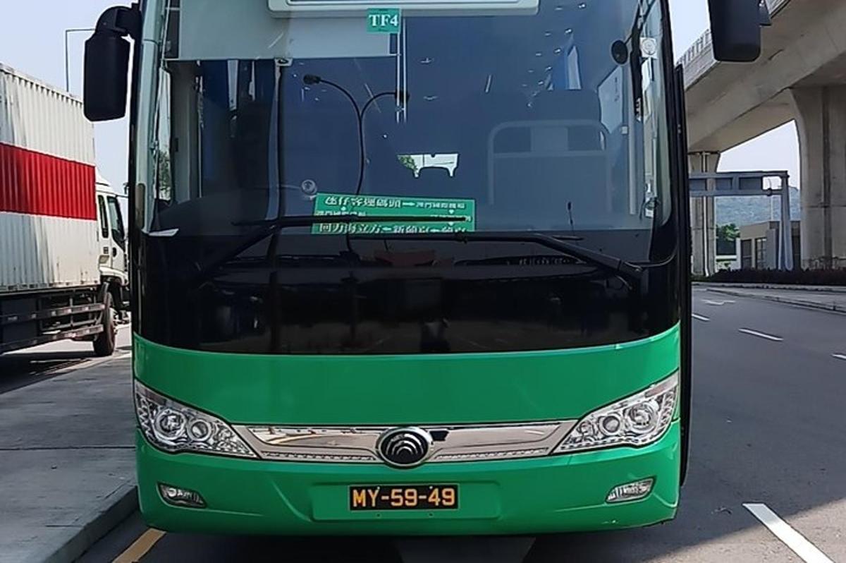 a green and black bus parked on a road