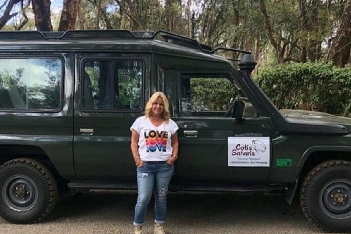 a woman standing in front of a green van