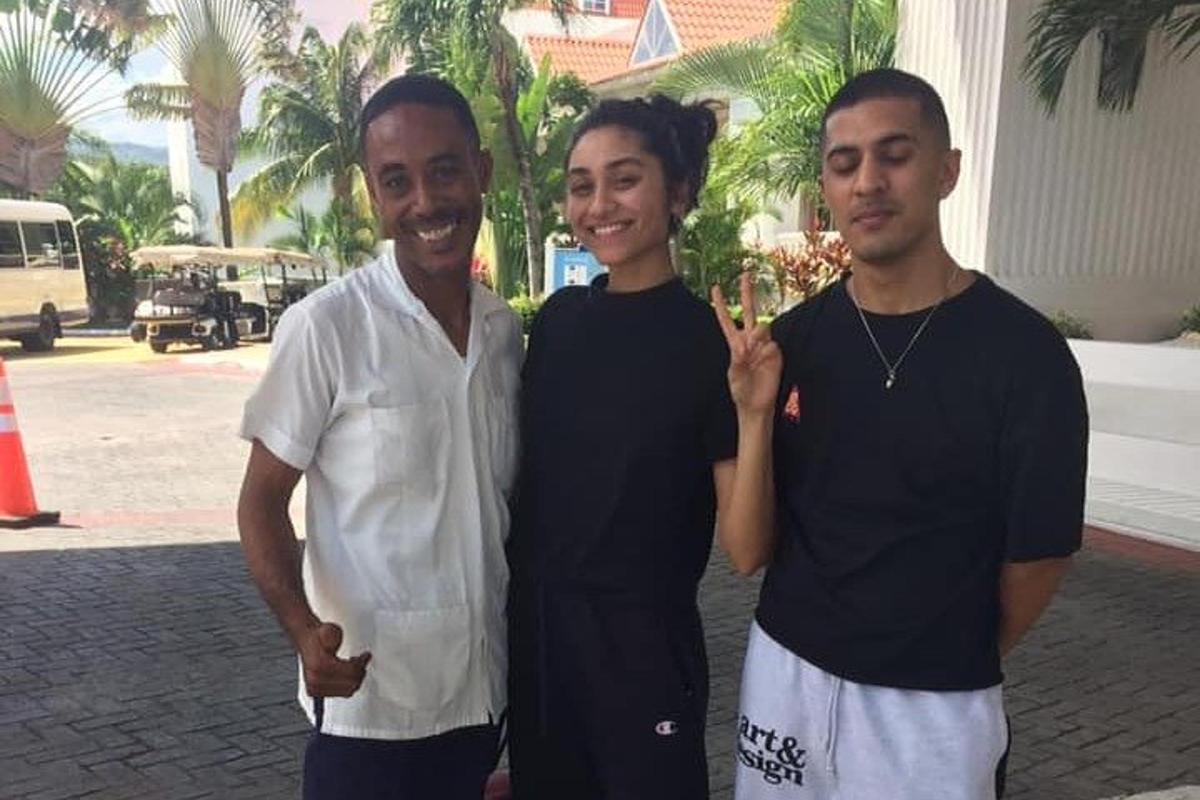 two men and a woman posing for a picture