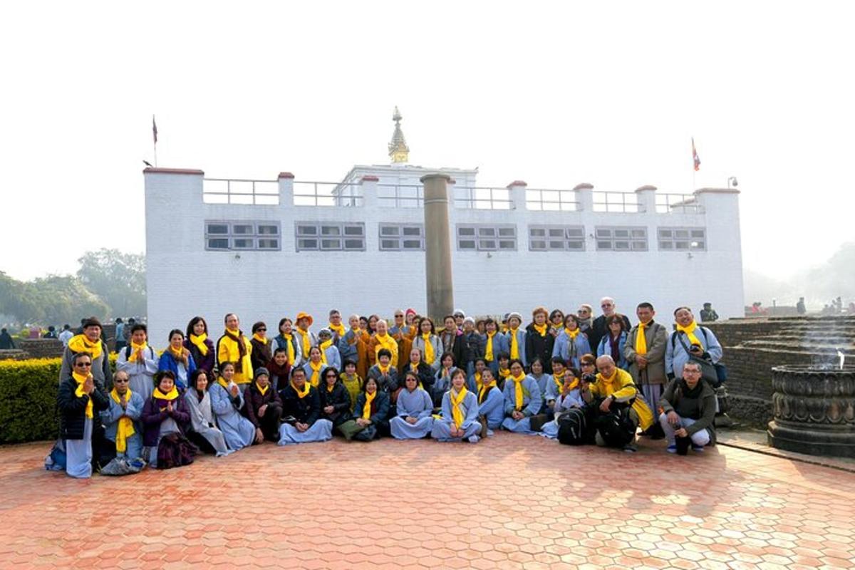 a group of people posing for a picture in front of a building