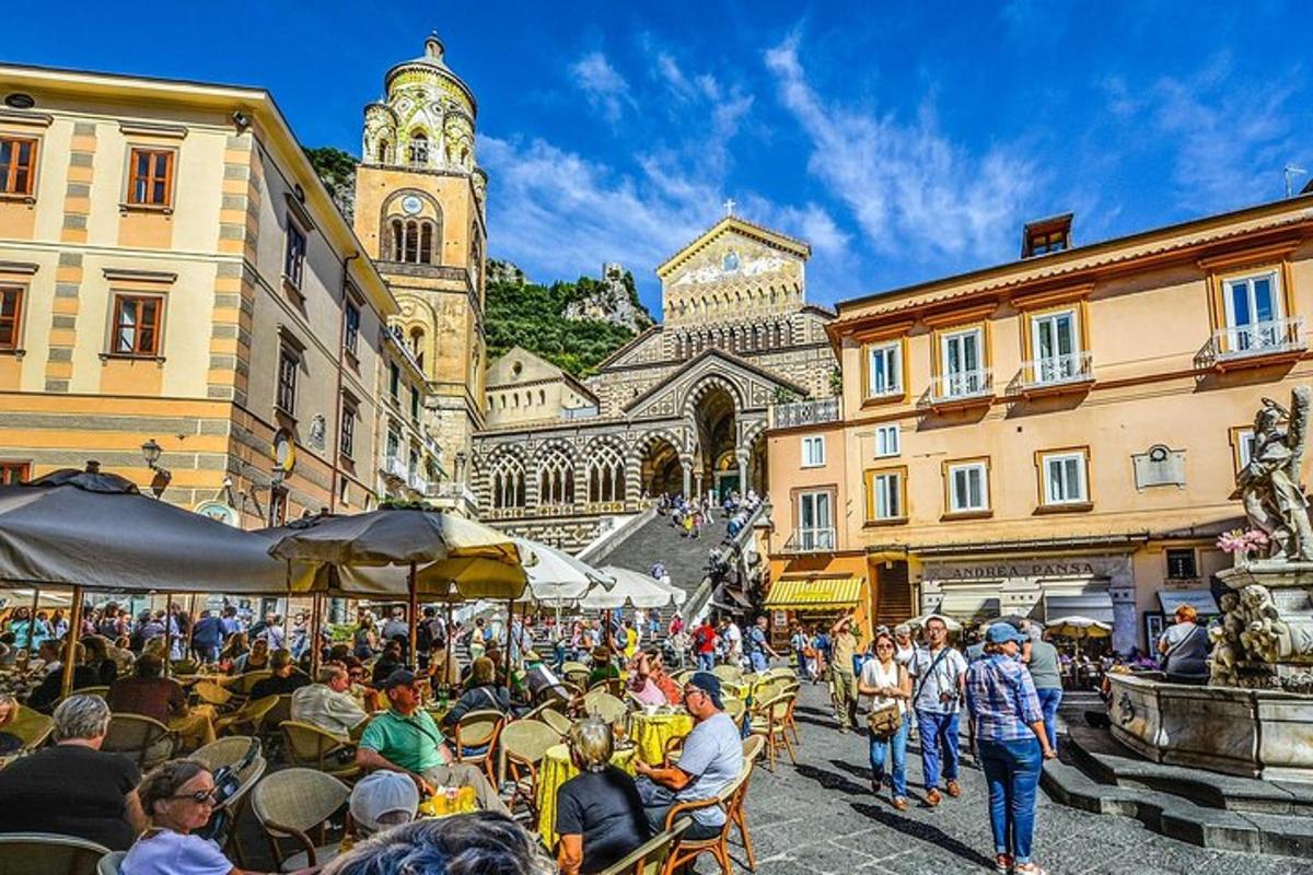a group of people sitting at tables in a street