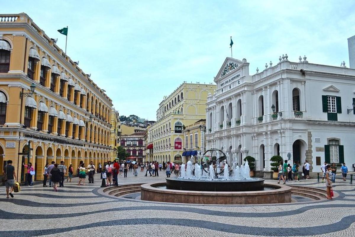 a street with a fountain in the middle of a city