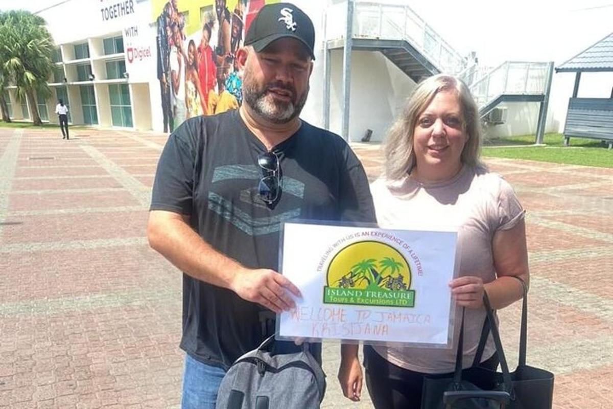 a man and a woman holding a sign