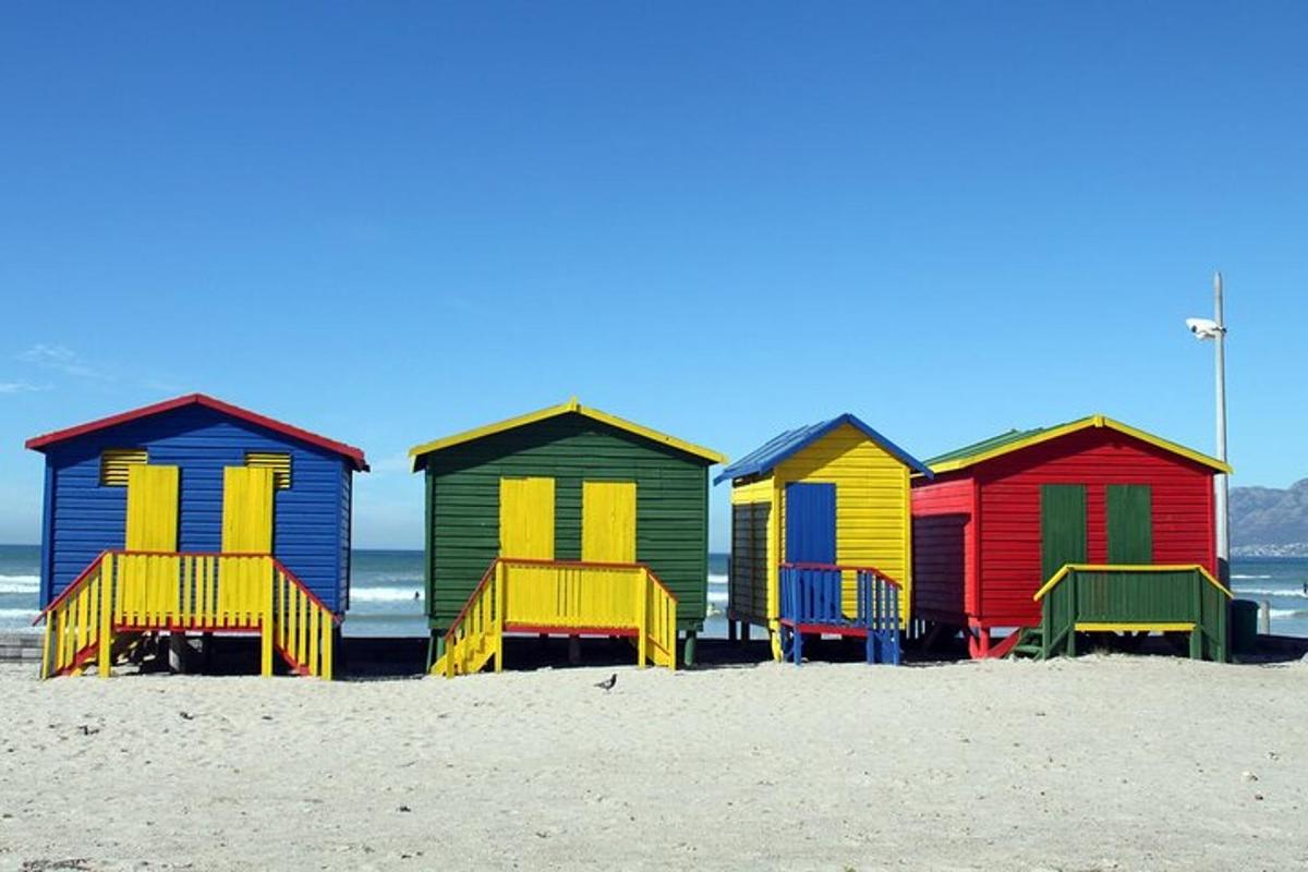 a row of colorful beach huts on the beach