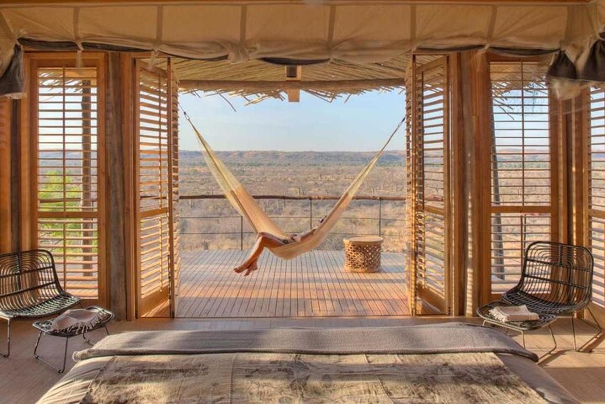 a bedroom with a hammock and a large window