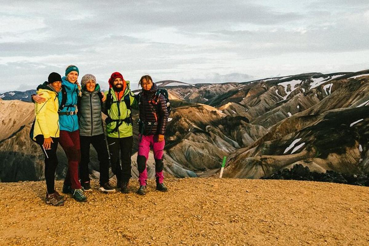a group of people standing on top of a mountain