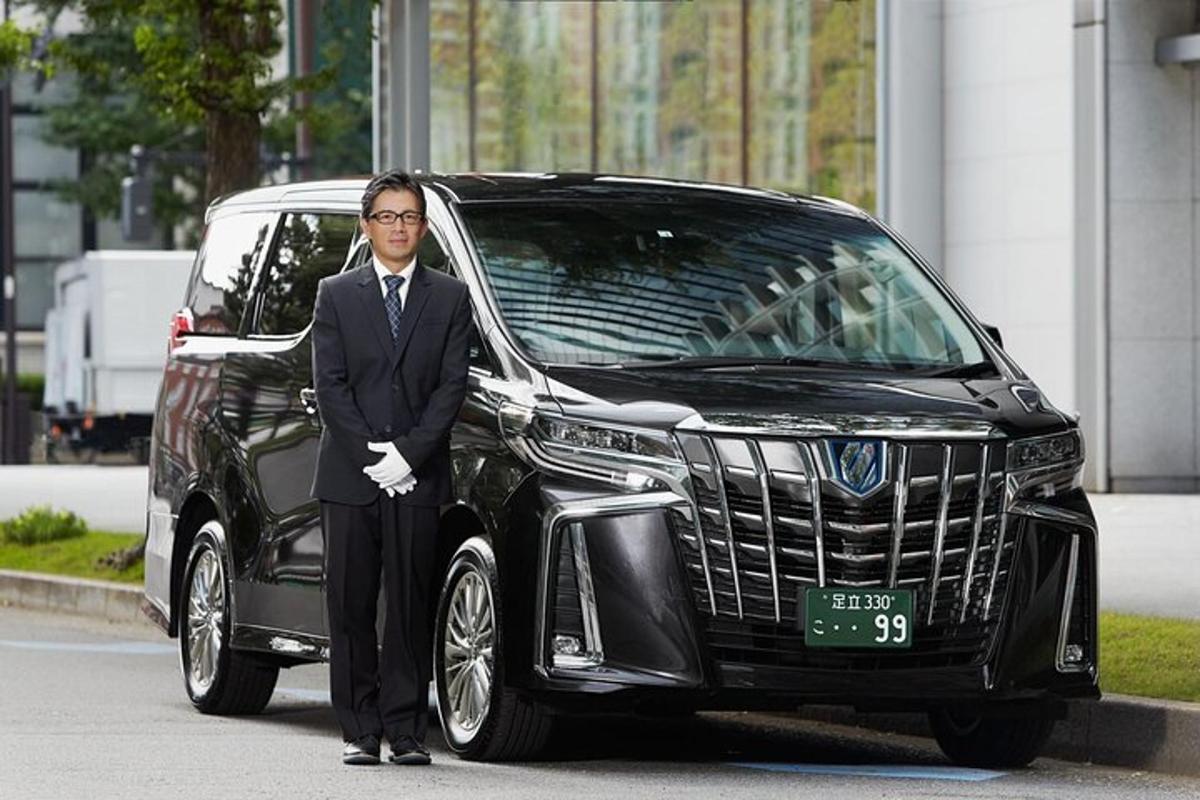 a man in a suit standing in front of a car